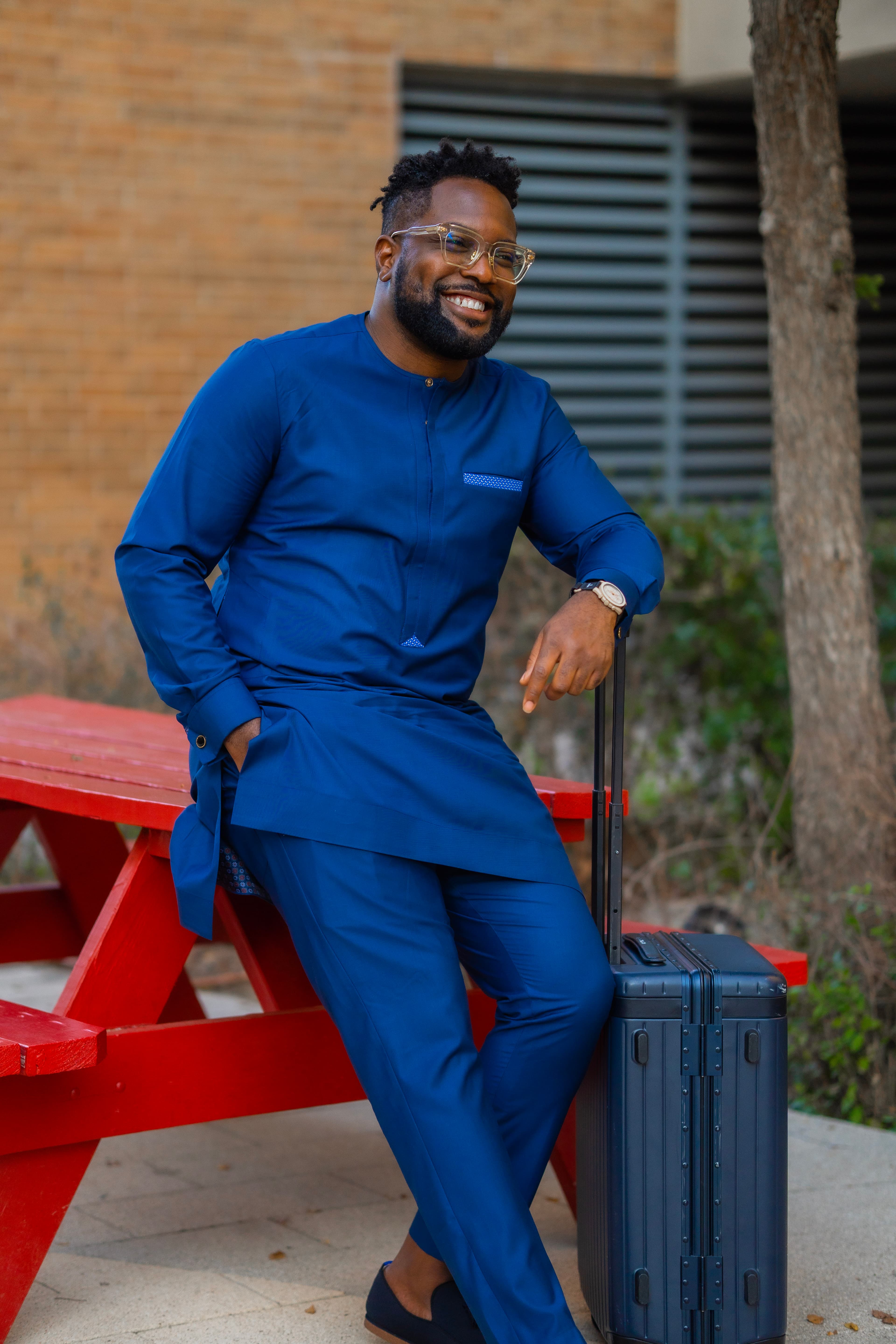 Model in navy traditional attire with pocket detail