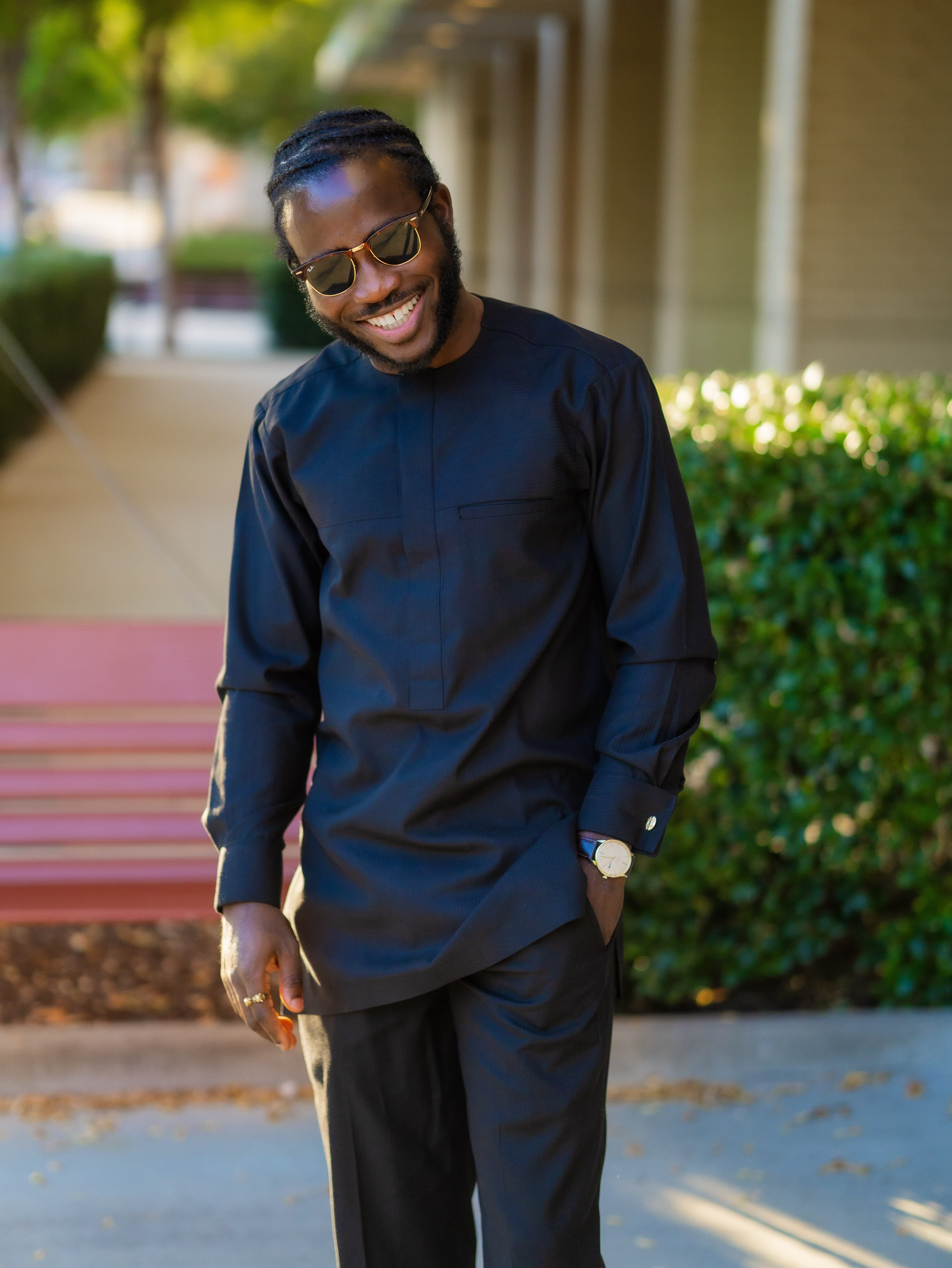 Model in dark traditional attire with purple headwear
